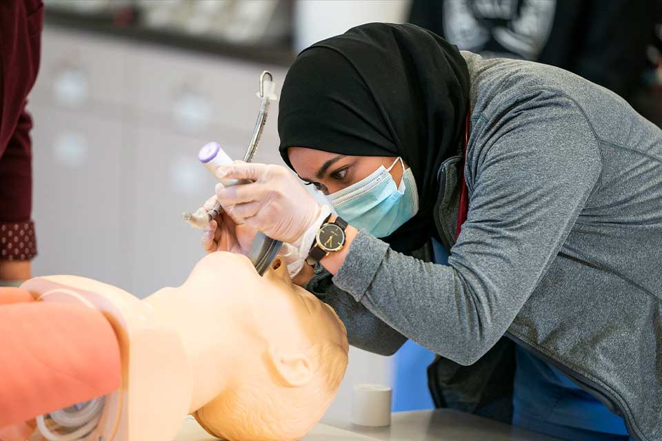 international student practices clinical procedures in the simulation lab
