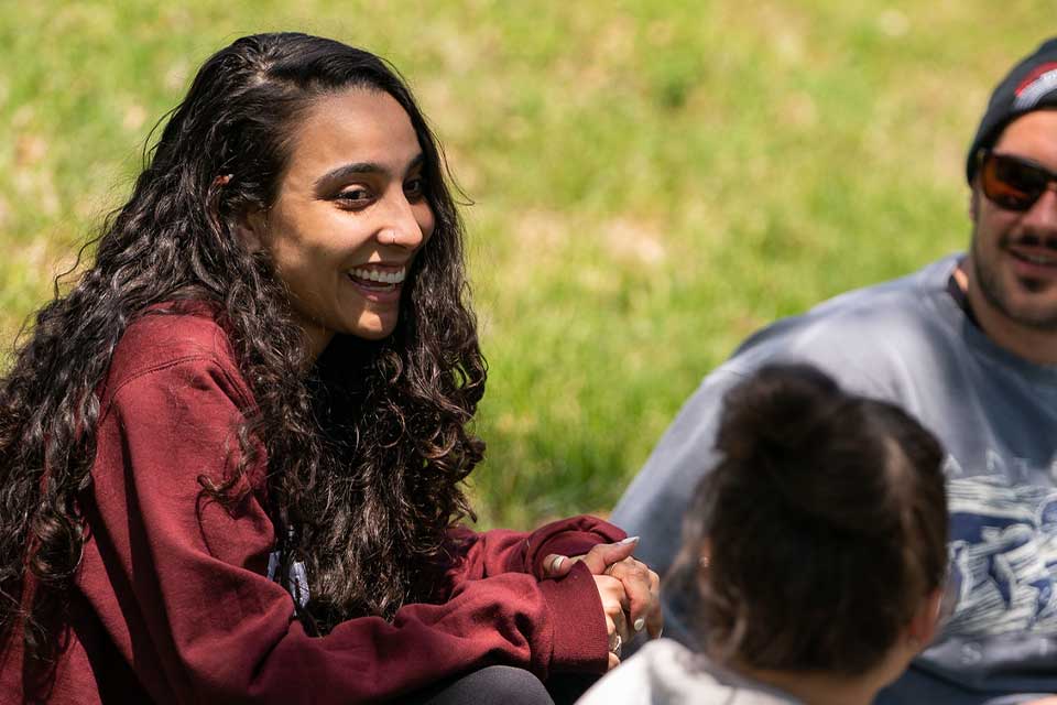 visiting student talks to friends in the quad