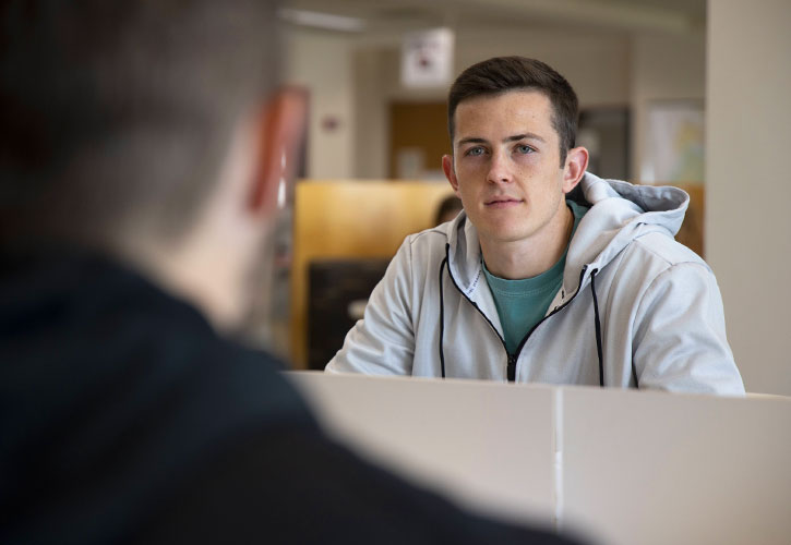 Two students sitting across from one another