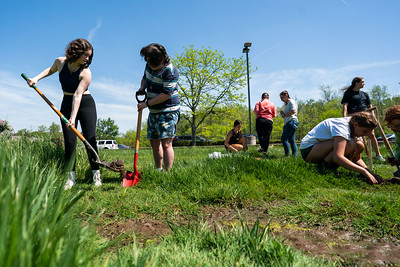 Students work in a garden