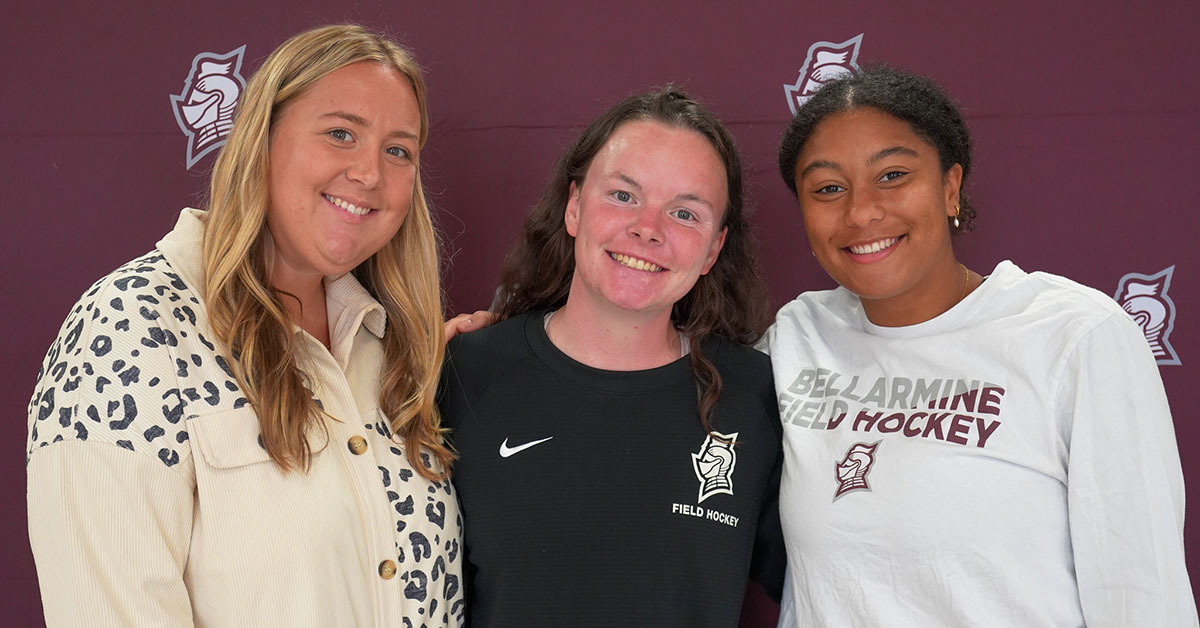 Three students smiling