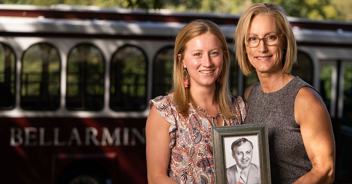 Two people holding a photo