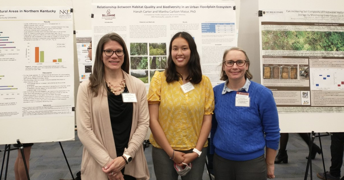 Three people standing and posing for the camera