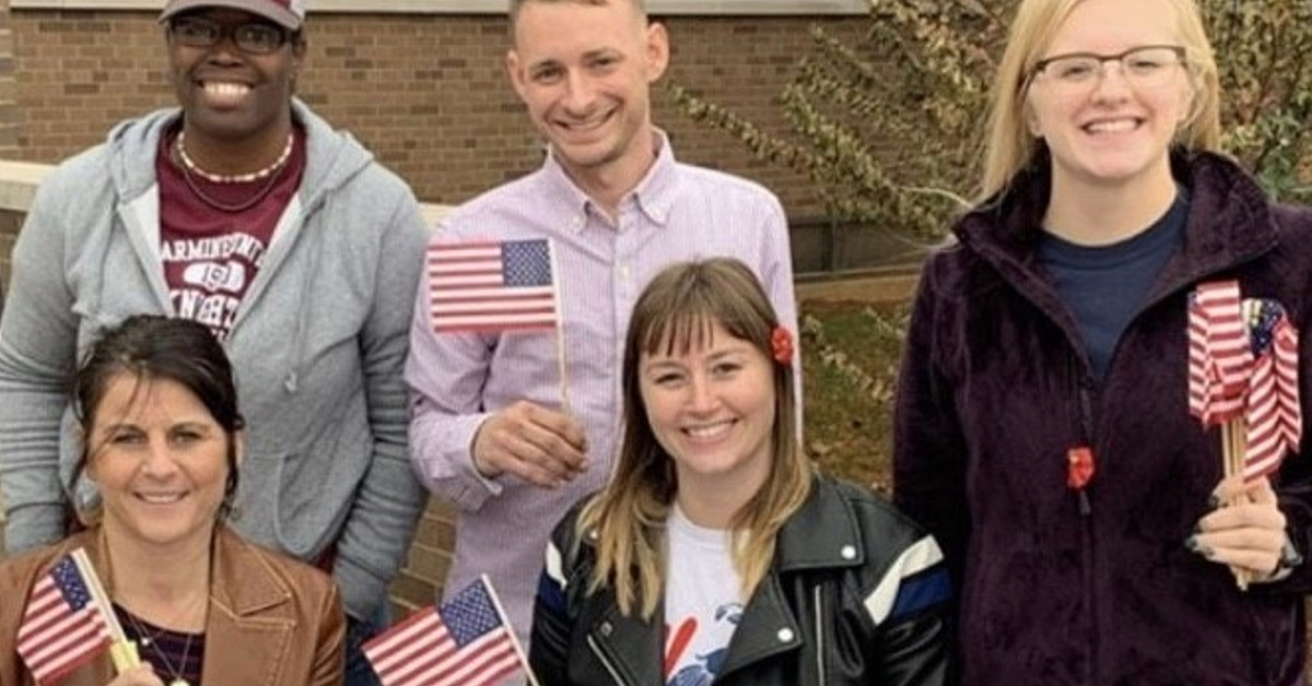 A group of students holding American flags